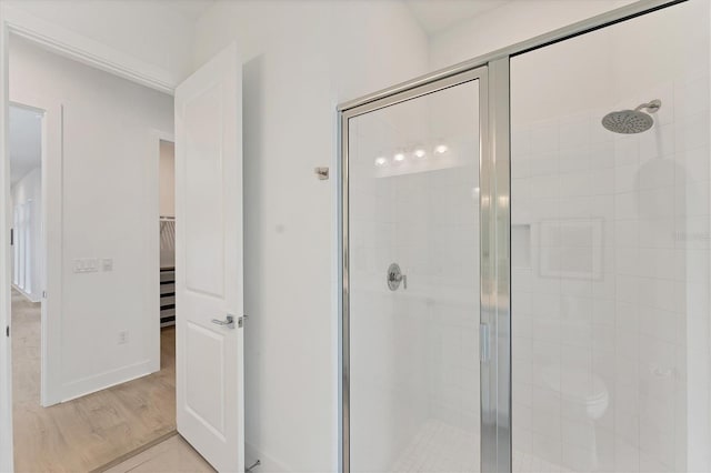 6028 Red Mangrove Ln, Bradenton, FL 34210 - bathroom featuring a stall shower, a walk in closet, and wood finished floors