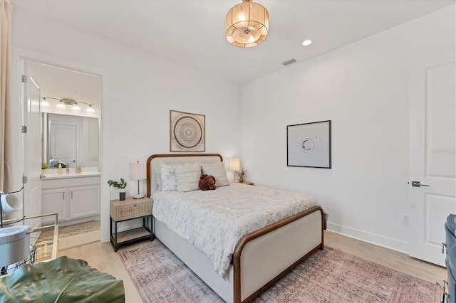6028 Red Mangrove Ln, Bradenton, FL 34210 - bedroom with light wood-style floors and ensuite bath