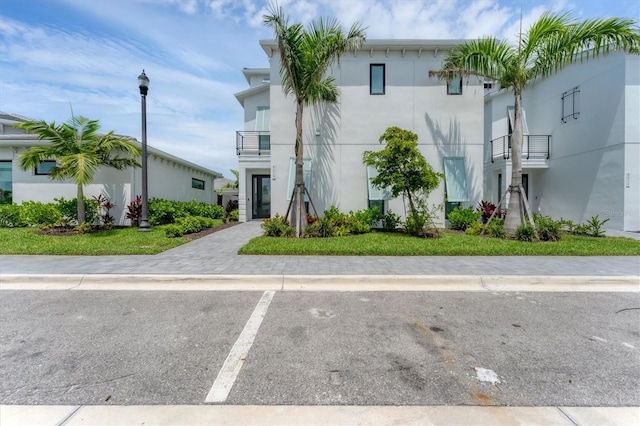 6028 Red Mangrove Ln, Bradenton, FL 34210 - view of front of home featuring stucco siding and a balcony