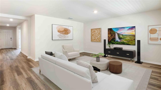 12071 Mountain Island Trl, Parrish, FL 34219 - living room featuring wood finished floors and recessed lighting