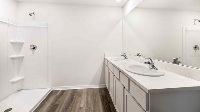 12071 Mountain Island Trl, Parrish, FL 34219 - full bath featuring wood finished floors, double vanity, and a shower