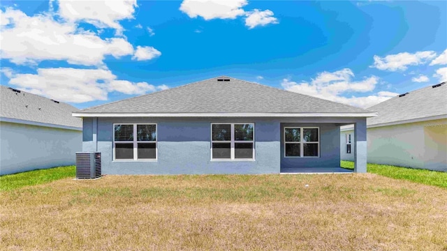 12071 Mountain Island Trl, Parrish, FL 34219 - rear view of property with a shingled roof, stucco siding, a lawn, and a patio