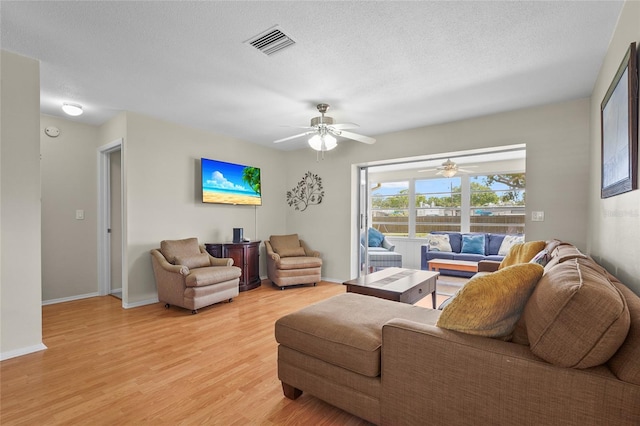409 Archibald Ave, Sarasota, FL 34243 - living room with light wood-style floors, ceiling fan, and a textured ceiling