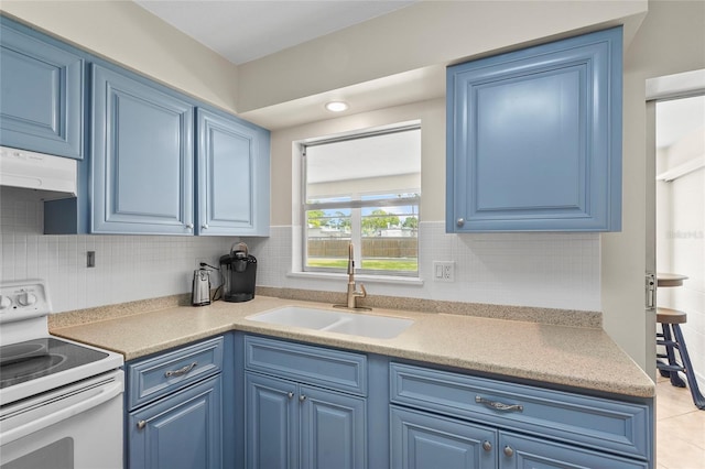 409 Archibald Ave, Sarasota, FL 34243 - kitchen featuring white range with electric stovetop, blue cabinets, under cabinet range hood, and tasteful backsplash