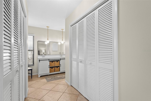 409 Archibald Ave, Sarasota, FL 34243 - hallway featuring light tile patterned flooring and a sink
