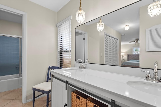 409 Archibald Ave, Sarasota, FL 34243 - ensuite bathroom with double vanity, tile patterned floors, enclosed tub / shower combo, and ceiling fan
