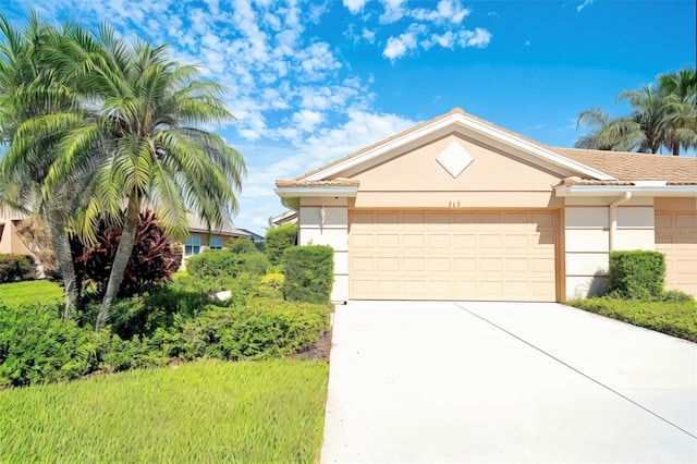 362 Fairway Isles Ln, Bradenton, FL 34212 - ranch-style house with stucco siding, concrete driveway, and a garage