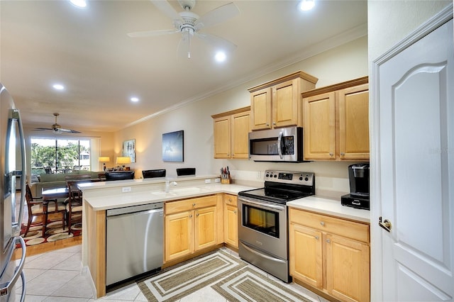 362 Fairway Isles Ln, Bradenton, FL 34212 - kitchen with stainless steel appliances, open floor plan, a peninsula, a ceiling fan, and ornamental molding