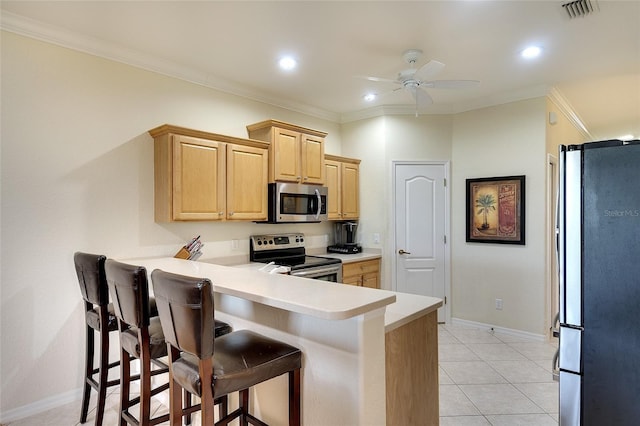 362 Fairway Isles Ln, Bradenton, FL 34212 - kitchen featuring appliances with stainless steel finishes, light brown cabinetry, a breakfast bar area, light countertops, and crown molding