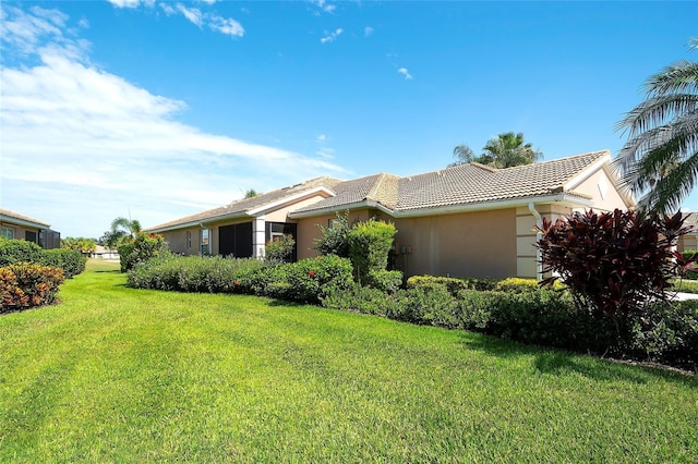362 Fairway Isles Ln, Bradenton, FL 34212 - view of front of house with stucco siding, a tiled roof, and a front lawn