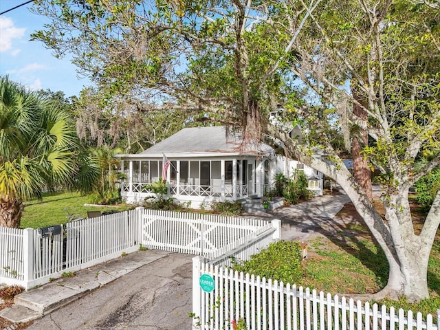 520 27th St W, Bradenton, FL 34205 - view of front of property featuring a sunroom, a fenced front yard, and a gate