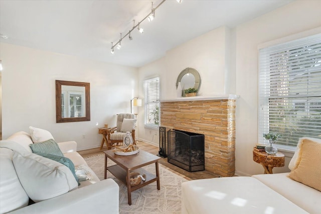 520 27th St W, Bradenton, FL 34205 - living room featuring track lighting, light wood finished floors, and a fireplace