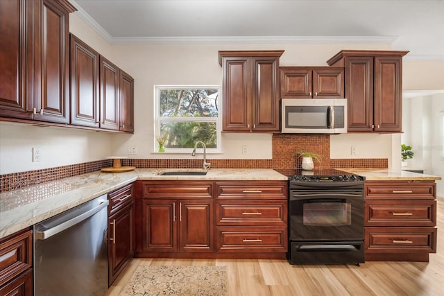 520 27th St W, Bradenton, FL 34205 - kitchen featuring appliances with stainless steel finishes, light wood finished floors, light stone counters, crown molding, and tasteful backsplash