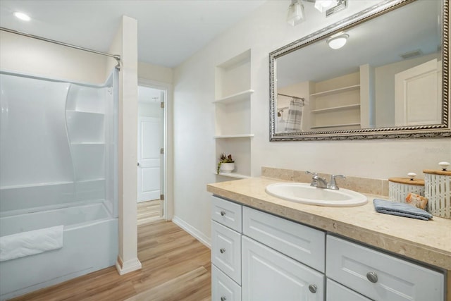 520 27th St W, Bradenton, FL 34205 - full bathroom featuring vanity, wood finished floors, and shower / tub combo