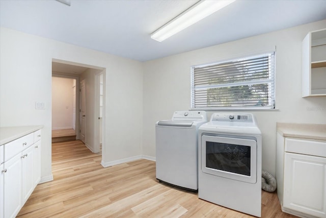 520 27th St W, Bradenton, FL 34205 - laundry area featuring cabinet space, separate washer and dryer, and light wood-type flooring