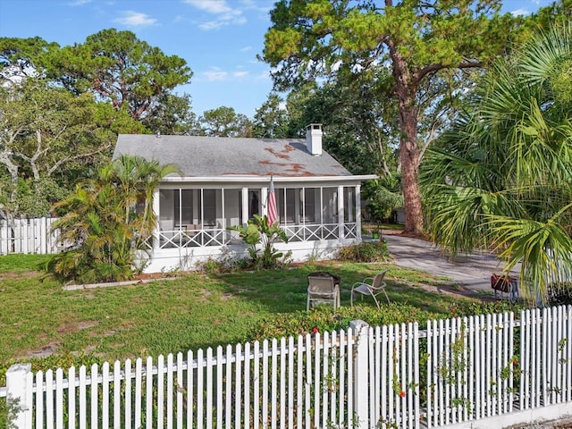 520 27th St W, Bradenton, FL 34205 - view of front of property featuring a sunroom, a chimney, and a shingled roof