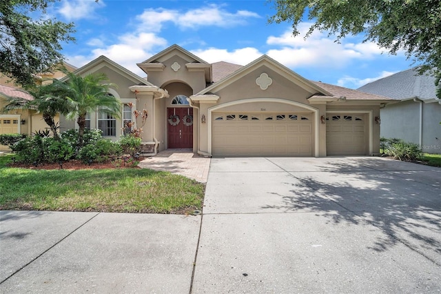 3041 Stonegate Falls Dr, Land O Lakes, FL 34638 - view of front facade featuring stucco siding, a garage, and concrete driveway