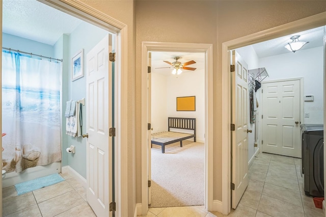 3041 Stonegate Falls Dr, Land O Lakes, FL 34638 - hall featuring light tile patterned floors and washer / dryer