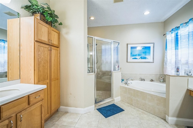 3041 Stonegate Falls Dr, Land O Lakes, FL 34638 - full bathroom featuring vanity, a shower stall, a garden tub, tile patterned flooring, and recessed lighting