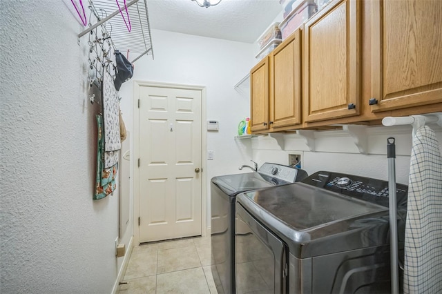 3041 Stonegate Falls Dr, Land O Lakes, FL 34638 - laundry room with cabinet space, independent washer and dryer, light tile patterned floors, and a textured wall