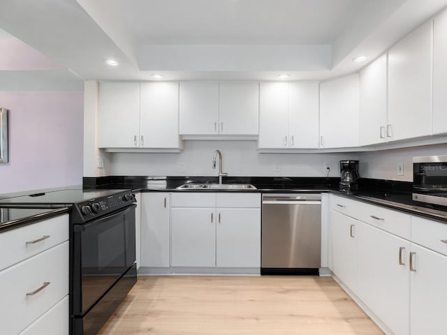 2295 Gulf Of Mexico Dr Unit 64S, Longboat Key, FL 34228 - kitchen with dishwasher, electric range, recessed lighting, white cabinets, and dark countertops
