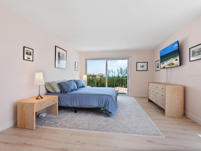 2295 Gulf Of Mexico Dr Unit 64S, Longboat Key, FL 34228 - bedroom with access to outside and light wood-style floors