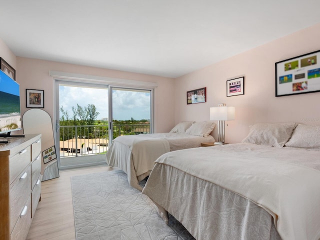 2295 Gulf Of Mexico Dr Unit 64S, Longboat Key, FL 34228 - bedroom featuring access to outside and light wood finished floors