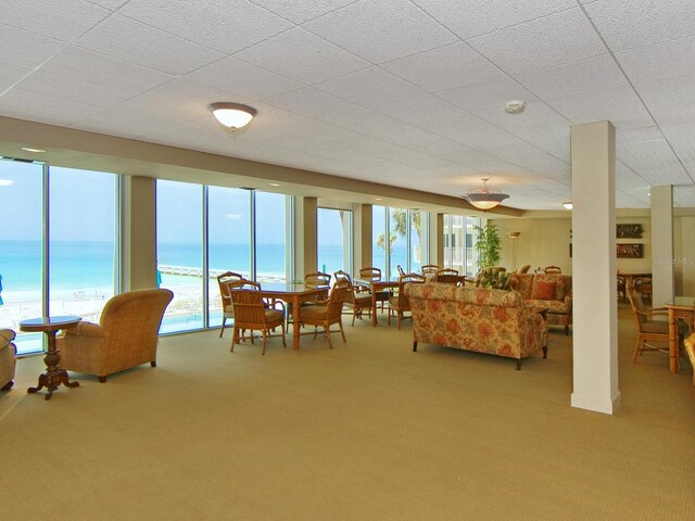 2295 Gulf Of Mexico Dr Unit 64S, Longboat Key, FL 34228 - carpeted living room featuring healthy amount of natural light and a water view
