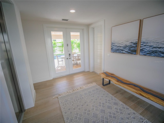 111 6th St N, Bradenton Beach, FL 34217 - doorway featuring french doors, wood finished floors, and recessed lighting