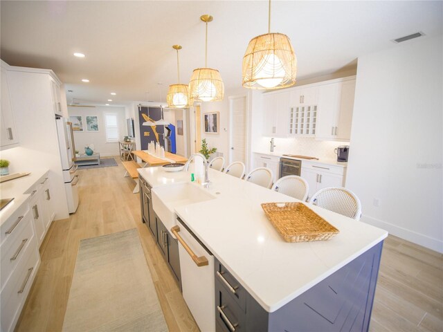 111 6th St N, Bradenton Beach, FL 34217 - kitchen featuring white appliances, a spacious island, white cabinetry, and recessed lighting