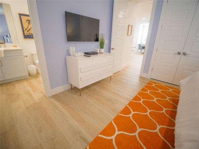 111 6th St N, Bradenton Beach, FL 34217 - bedroom featuring light wood finished floors and connected bathroom