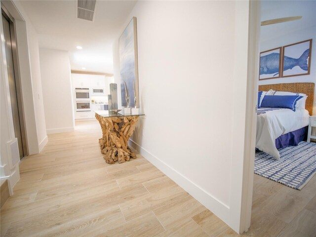 111 6th St N, Bradenton Beach, FL 34217 - hall with light wood-style floors and recessed lighting