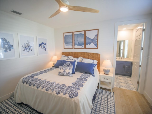111 6th St N, Bradenton Beach, FL 34217 - bedroom featuring wood finished floors, ceiling fan, and ensuite bath