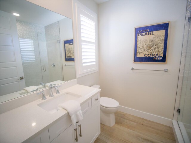 111 6th St N, Bradenton Beach, FL 34217 - bathroom featuring wood finished floors, a stall shower, and vanity