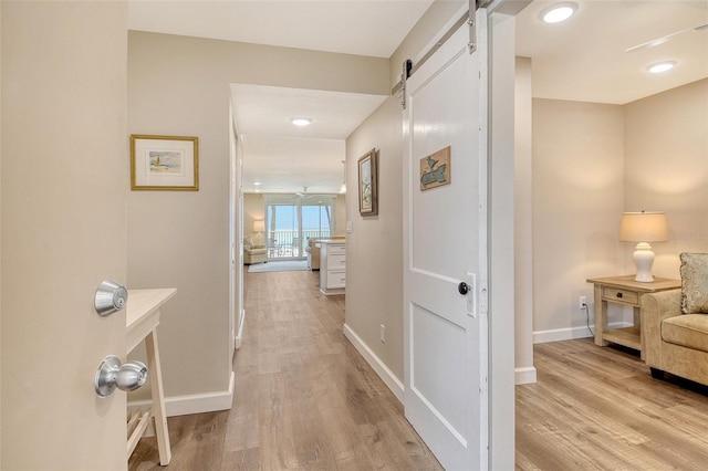 4325 Gulf Of Mexico Dr Unit 204, Longboat Key, FL 34228 - hall with a barn door and light wood finished floors