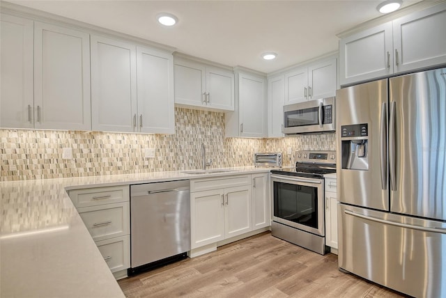 4325 Gulf Of Mexico Dr Unit 204, Longboat Key, FL 34228 - kitchen featuring appliances with stainless steel finishes, light countertops, white cabinetry, and recessed lighting