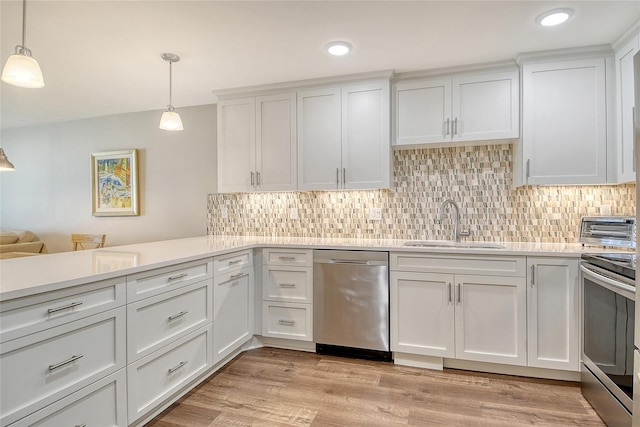4325 Gulf Of Mexico Dr Unit 204, Longboat Key, FL 34228 - kitchen featuring stainless steel appliances, light countertops, decorative backsplash, white cabinets, and recessed lighting