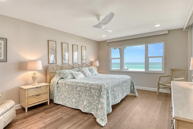4325 Gulf Of Mexico Dr Unit 204, Longboat Key, FL 34228 - bedroom with wood finished floors and a ceiling fan