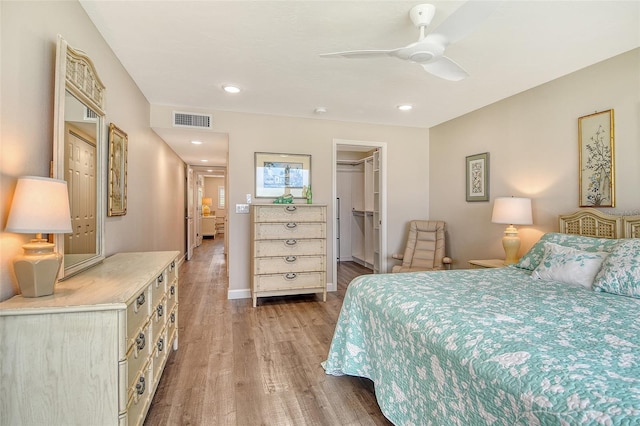 4325 Gulf Of Mexico Dr Unit 204, Longboat Key, FL 34228 - bedroom featuring light wood-type flooring, a spacious closet, ceiling fan, recessed lighting, and a closet