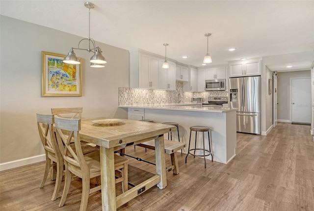 4325 Gulf Of Mexico Dr Unit 204, Longboat Key, FL 34228 - dining area with light wood-type flooring and recessed lighting