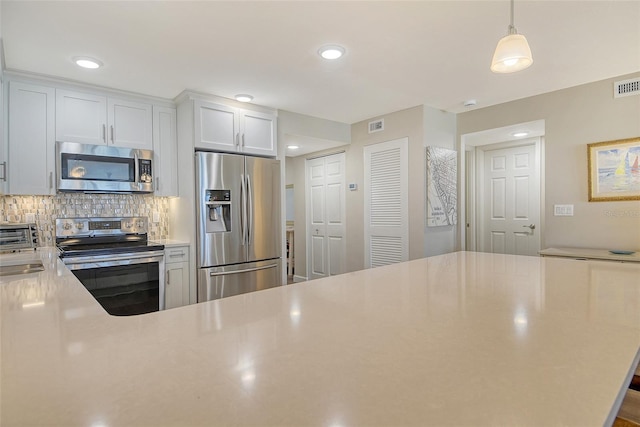 4325 Gulf Of Mexico Dr Unit 204, Longboat Key, FL 34228 - kitchen with stainless steel appliances, light countertops, tasteful backsplash, recessed lighting, and decorative light fixtures