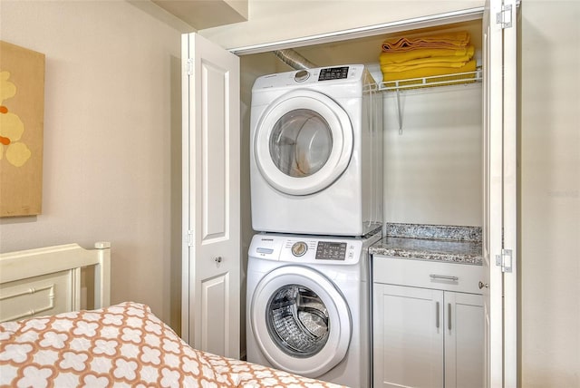 4325 Gulf Of Mexico Dr Unit 204, Longboat Key, FL 34228 - laundry room featuring stacked washing machine and dryer