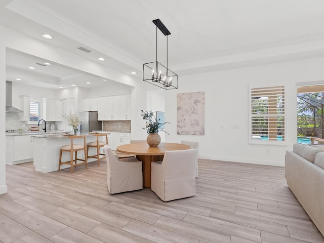 10120 Carnoustie Pl, Bradenton, FL 34211 - dining area with ornamental molding, wood finish floors, recessed lighting, a chandelier, and a raised ceiling