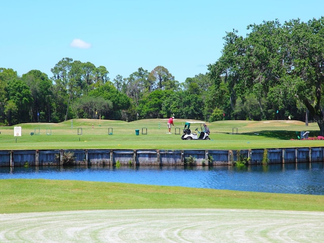 10120 Carnoustie Pl, Bradenton, FL 34211 - view of home's community featuring view of wooded area, a water view, a lawn, and golf course view