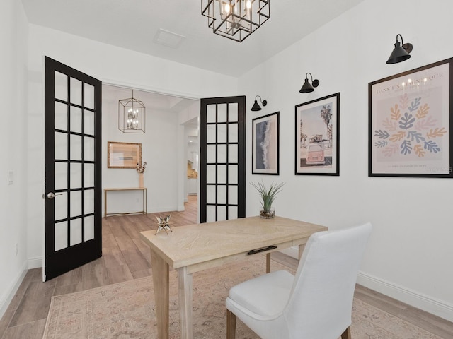 10120 Carnoustie Pl, Bradenton, FL 34211 - office space featuring a chandelier, wood finished floors, and french doors