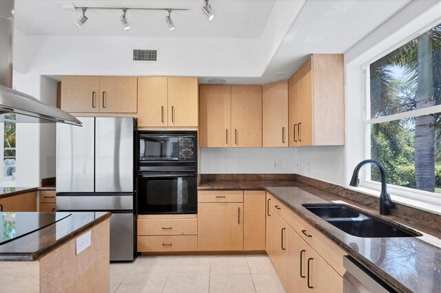 1168 Westway Dr, Sarasota, FL 34236 - kitchen featuring black appliances, light brown cabinets, wall chimney range hood, and light tile patterned floors
