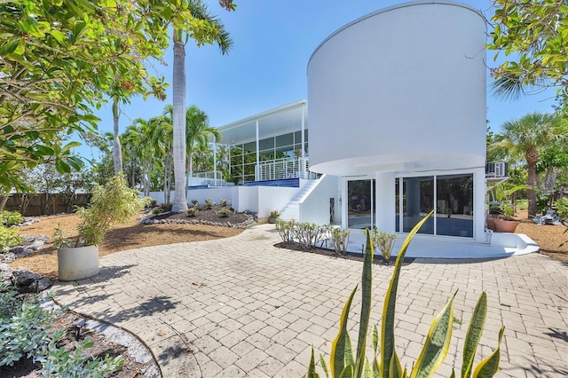 1168 Westway Dr, Sarasota, FL 34236 - view of patio / terrace with a sunroom and stairs