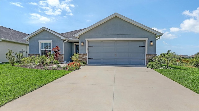 6435 165th Dr E, Parrish, FL 34219 - single story home with stone siding, stucco siding, concrete driveway, an attached garage, and a front yard