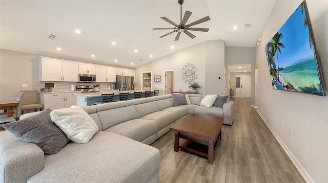 6435 165th Dr E, Parrish, FL 34219 - living area with light wood finished floors, ceiling fan, recessed lighting, and high vaulted ceiling