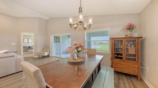 6435 165th Dr E, Parrish, FL 34219 - dining room with wood finished floors, a chandelier, and lofted ceiling